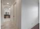 Hallway leading to a bathroom featuring tiled floors and a vanity with green marble, with views to the hallway at 5020 W Dickens Ave, Tampa, FL 33629
