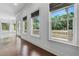 Bright hallway with dark hardwood floors and several windows with views of the pool and patio area at 5020 W Dickens Ave, Tampa, FL 33629