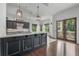 Kitchen featuring a center island, dark cabinetry, tile backsplash, and stainless steel appliances at 5020 W Dickens Ave, Tampa, FL 33629