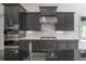 Gourmet kitchen boasts stainless steel appliances, white countertops and custom cabinetry at 5020 W Dickens Ave, Tampa, FL 33629