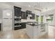 Modern kitchen with stainless steel appliances, a center island, and dark cabinetry at 5020 W Dickens Ave, Tampa, FL 33629