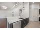 Modern kitchen boasts white quartz countertops, stainless steel appliances and designer pendant lighting at 5020 W Dickens Ave, Tampa, FL 33629