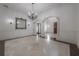 Spacious living room with a decorative wall mirror and views into the entry foyer at 5020 W Dickens Ave, Tampa, FL 33629