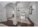 Expansive living room with decorative columns, travertine floors, and a grand chandelier at 5020 W Dickens Ave, Tampa, FL 33629