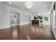 Spacious living area with dark hardwood floors and smooth transition into kitchen with breakfast bar at 5020 W Dickens Ave, Tampa, FL 33629
