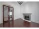 Living room featuring dark hardwood floors, a gray fireplace, and glass paneled doors at 5020 W Dickens Ave, Tampa, FL 33629