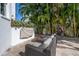 Cozy outdoor seating area on a stone patio, surrounded by vibrant tropical plants and trees at 5020 W Dickens Ave, Tampa, FL 33629