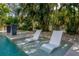In-pool chaise lounges and potted plants create a relaxing pool atmosphere at 5020 W Dickens Ave, Tampa, FL 33629