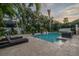 An elegant pool with patio and lounge chairs surrounded by lush tropical landscaping at 5020 W Dickens Ave, Tampa, FL 33629