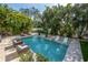 Inviting pool area surrounded by tropical landscaping, perfect for relaxation and outdoor enjoyment at 5020 W Dickens Ave, Tampa, FL 33629
