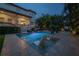 Backyard pool with shallow tanning deck, lounge chairs, and lush tropical foliage at 5020 W Dickens Ave, Tampa, FL 33629