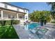 Stunning pool with in-water loungers, surrounded by lush landscaping and a beautiful backyard at 5020 W Dickens Ave, Tampa, FL 33629