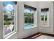 Bright breakfast area featuring a window view of the pool and patio area surrounded by tropical foliage at 5020 W Dickens Ave, Tampa, FL 33629