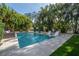 Inviting pool with in-water loungers and outdoor seating surrounded by beautiful landscaping at 5020 W Dickens Ave, Tampa, FL 33629