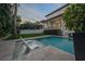 Inviting backyard pool with lounge chairs, lush landscaping, and a covered porch at 5020 W Dickens Ave, Tampa, FL 33629