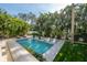 Gorgeous outdoor living area with a beautiful pool and lush tropical landscaping for ultimate relaxation at 5020 W Dickens Ave, Tampa, FL 33629