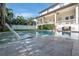 Backyard pool with lounge chair in the water and a partial view of the house at 5020 W Dickens Ave, Tampa, FL 33629