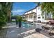 Backyard pool and patio with lush tropical landscaping surrounding comfortable lounge furniture at 5020 W Dickens Ave, Tampa, FL 33629