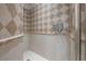 Modern shower featuring decorative tile work, built-in dispensers, and a sleek showerhead at 5020 W Dickens Ave, Tampa, FL 33629