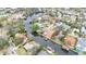 Aerial view of the home, surrounded by trees, situated on a waterfront canal at 513 Suwanee Cir, Tampa, FL 33606