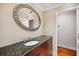 Stylish bathroom with granite countertops, a decorative mirror, and modern fixtures at 513 Suwanee Cir, Tampa, FL 33606