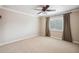 Bright, carpeted bedroom with a ceiling fan and large window featuring views of the outdoors at 513 Suwanee Cir, Tampa, FL 33606