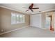 Cozy bedroom featuring plantation shutters and a ceiling fan for added comfort and style at 513 Suwanee Cir, Tampa, FL 33606