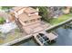 Aerial view of home featuring a dock with a boat lift, and a deck with a hot tub at 513 Suwanee Cir, Tampa, FL 33606