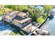 Aerial view of waterfront home featuring a large deck with a hot tub and a boat dock at 513 Suwanee Cir, Tampa, FL 33606