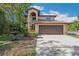 Charming two-story home with an arched entryway, complemented by a beautiful fountain and manicured landscaping at 513 Suwanee Cir, Tampa, FL 33606