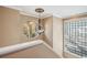 Charming hallway with a decorative chandelier and an arched window overlooking the outdoors at 513 Suwanee Cir, Tampa, FL 33606