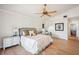 Bright main bedroom featuring a ceiling fan, wood floors, and ensuite bathroom at 513 Suwanee Cir, Tampa, FL 33606