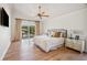 Bright main bedroom with a ceiling fan, walkout to deck, and neutral decor at 513 Suwanee Cir, Tampa, FL 33606