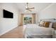 Bright main bedroom with ceiling fan and a walkout to a river view balcony at 513 Suwanee Cir, Tampa, FL 33606