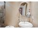 Elegant powder room with decorative mirror and pedestal sink at 513 Suwanee Cir, Tampa, FL 33606