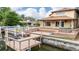 Back of house showcasing a spacious wooden deck with a hot tub, boat lift, and dock on the waterfront at 513 Suwanee Cir, Tampa, FL 33606