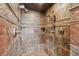 Bathroom with a beautifully tiled shower, rainfall showerhead, and convenient shelving at 513 Suwanee Cir, Tampa, FL 33606