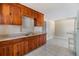 A simple kitchen area featuring a double sink, older cabinets, and basic appliances at 5130 Dr Martin Luther King Jr St S, St Petersburg, FL 33705