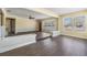 Bright living room featuring hardwood floors, neutral paint, and large windows that let in natural light at 5130 Dr Martin Luther King Jr St S, St Petersburg, FL 33705