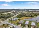 Aerial view of a quiet neighborhood with mature trees, ponds, and well-maintained homes at 5720 107Th E Ter, Parrish, FL 34219