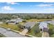 Aerial view of a residence with landscaping, a lawn, and tranquil water views in a well-kept community at 5720 107Th E Ter, Parrish, FL 34219