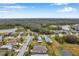 Wide aerial view of homes with lawns, ponds, and tree lined streets in a quiet neighborhood at 5720 107Th E Ter, Parrish, FL 34219