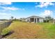 Large, fenced backyard features a well-maintained lawn and a screened in lanai at 5720 107Th E Ter, Parrish, FL 34219