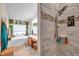 Primary bath showing tub, separate tiled shower, and vanity with double sinks and cabinets at 5720 107Th E Ter, Parrish, FL 34219