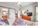 Bright bedroom featuring a barn door leading to the bathroom, complemented by neutral décor at 5720 107Th E Ter, Parrish, FL 34219