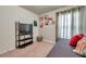 Cozy bedroom showcasing a daybed near the window, complemented by carpeted floors and neutral walls at 5720 107Th E Ter, Parrish, FL 34219