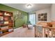 Bedroom room with an accent wall, a wooden crib, and a decorative tree with Gathering photos at 5720 107Th E Ter, Parrish, FL 34219