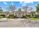 Stunning clubhouse featuring elegant stone accents, lush landscaping, and a welcoming entrance at 5720 107Th E Ter, Parrish, FL 34219