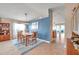 Elegant dining room with a modern chandelier, neutral paint and tile flooring, adjacent to the kitchen at 5720 107Th E Ter, Parrish, FL 34219