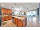 Bright open kitchen features wood cabinets, large center island, stainless appliances, and is open to the living area at 5720 107Th E Ter, Parrish, FL 34219